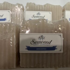 Stack of seaweed soap bars with natural packaging.