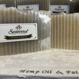 Close-up of natural soap bars labeled 'Seaweed' with hemp oil and patchouli.
