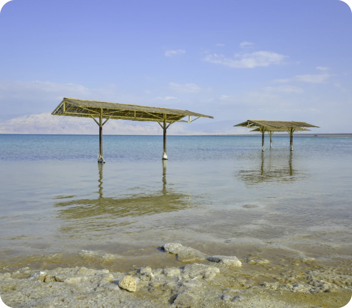 Beach canopies over calm sea
