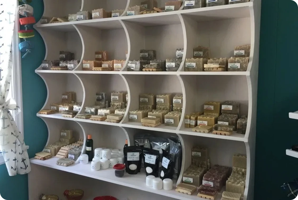 Assorted handmade soaps on display shelves