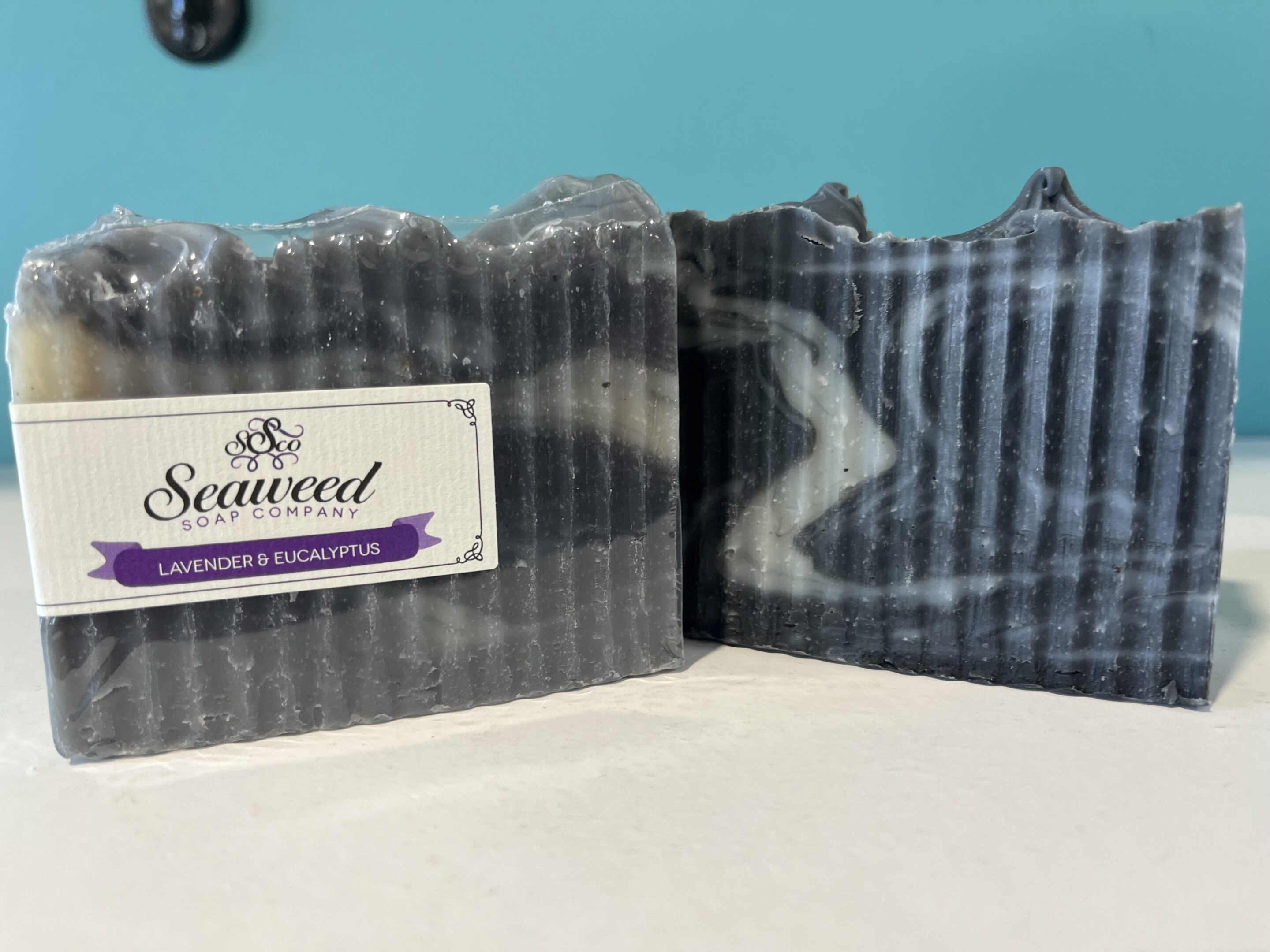 Two bars of striped seaweed soap with lavender labels.