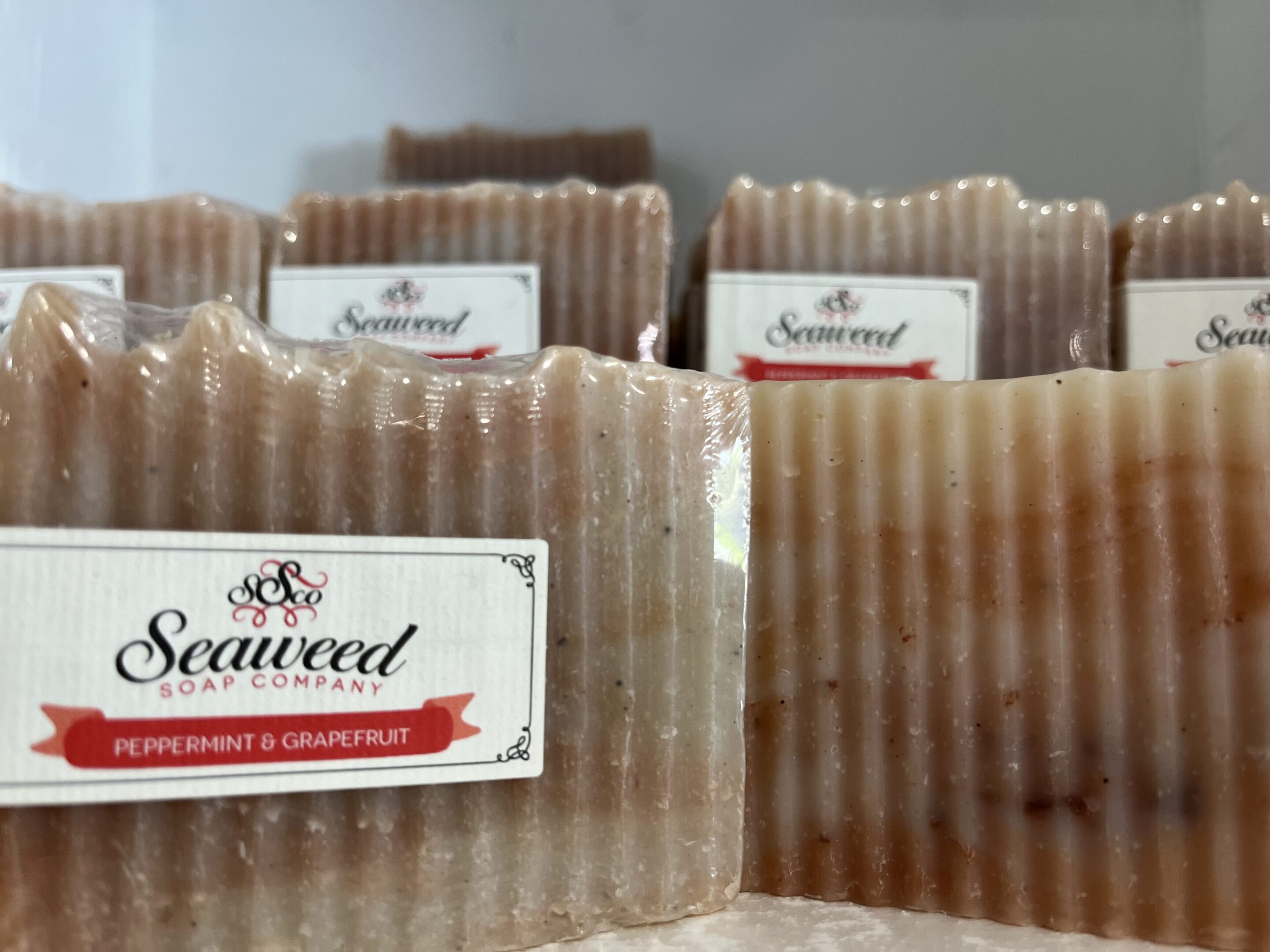 Handmade seaweed soap bars with natural texture and labels.